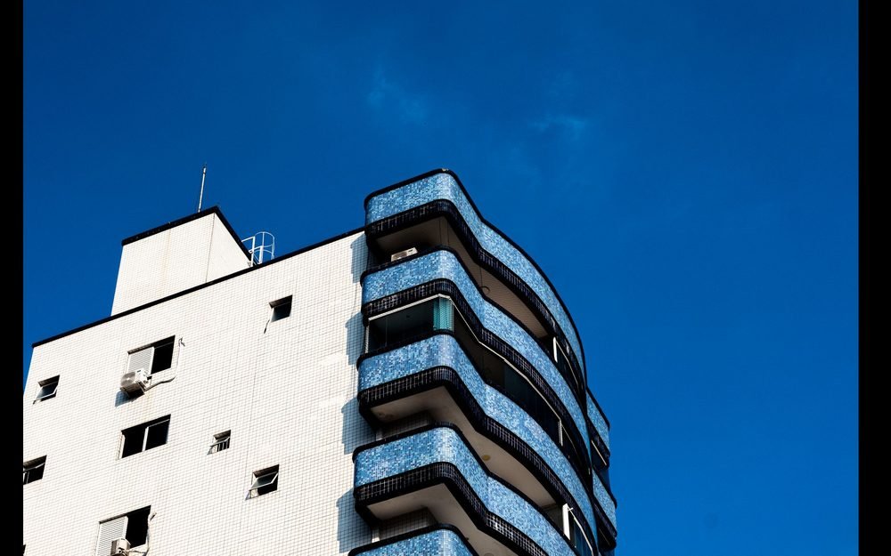 Prédio residencial moderno visto de baixo contra o céu